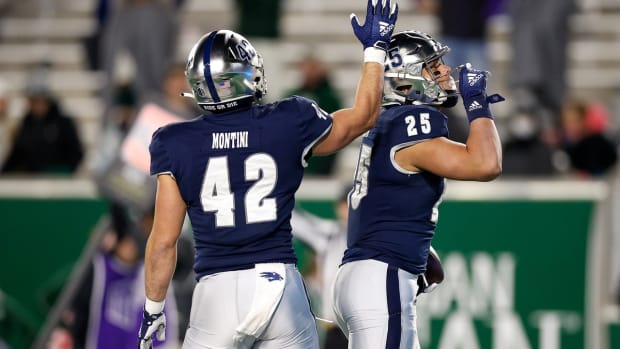 Nov 27, 2021; Fort Collins, Colorado, USA; Nevada Wolf Pack running back Avery Morrow (25) celebrates with linebacker Peter Montini (42) after a touchdown in the fourth quarter against the Colorado State Rams at Sonny Lubrick Field at Canvas Stadium. Mandatory Credit: Isaiah J. Downing-USA TODAY Sports